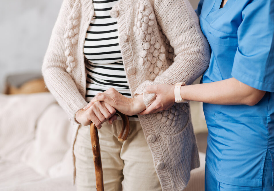 Gentle trained nurse helping mature patient